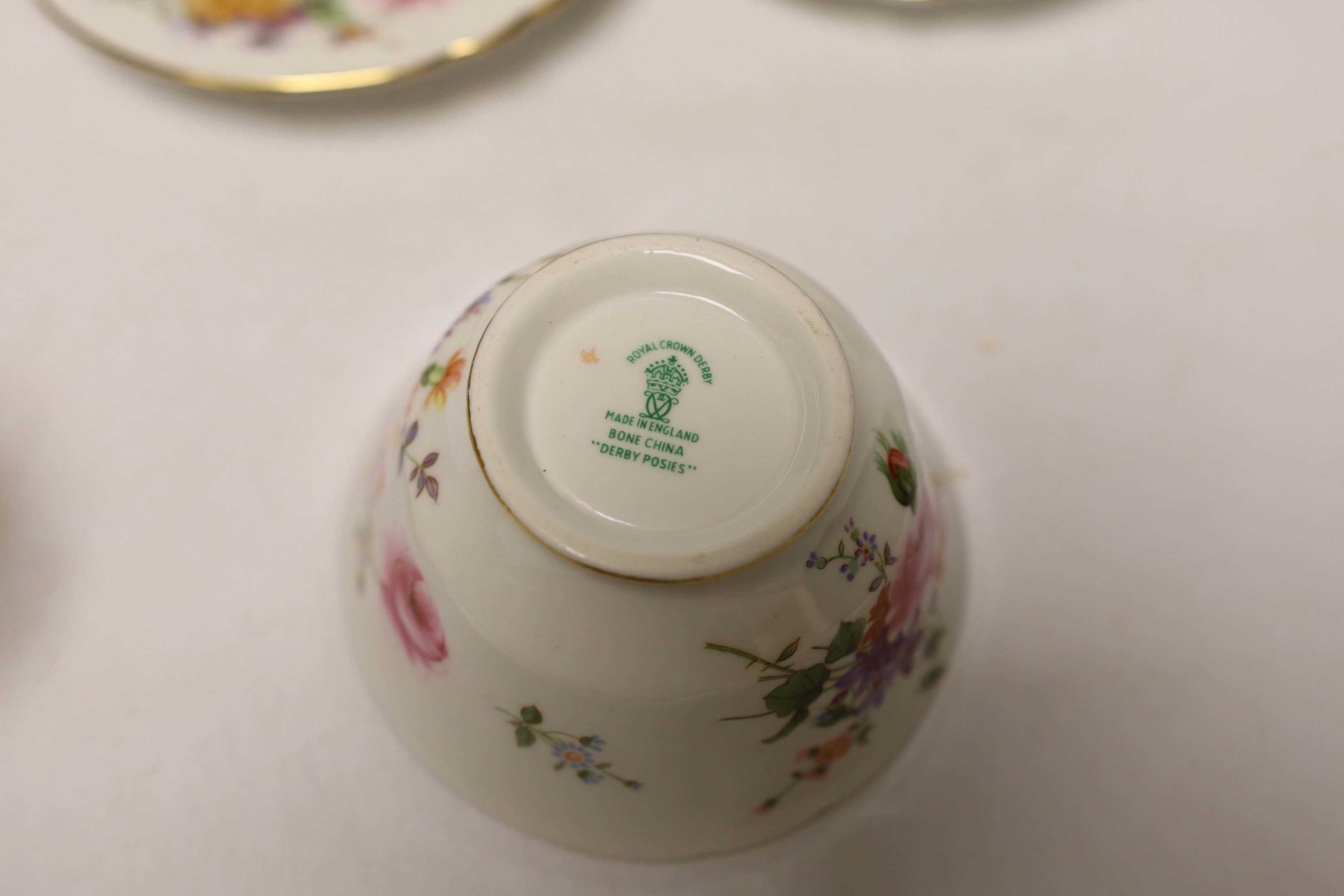 A Royal Crown Derby Posies coffee set comprising of seven cups and saucers, a sugar bowl and milk jug